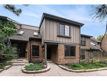 Charming townhome with brick facade, gray siding and well maintained landscaping at 8236 E Phillips Pl, Centennial, CO 80112