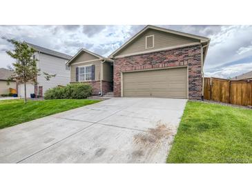 A charming home featuring a brick and siding exterior with an attached two-car garage and concrete driveway at 13667 Valentia St, Thornton, CO 80602