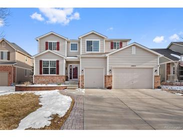 Charming two-story home with a well-manicured front yard and a two-car garage at 16844 E Lake Pl, Aurora, CO 80016