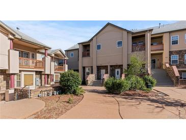Inviting townhouse with stone accents, balconies, and well-maintained landscaping at 10578 E Jewell Ave, Aurora, CO 80012