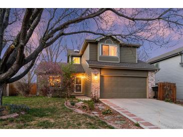 Charming two-story home with landscaped yard, brick accents, and attached two car garage at 12734 Eudora Dr, Thornton, CO 80241