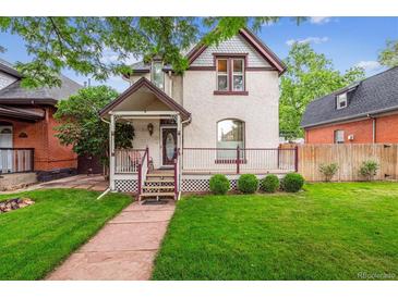 Charming home with a welcoming front porch and well-maintained lawn at 912 S Washington St, Denver, CO 80209
