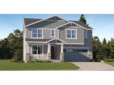 Two-story house with gray siding, stone accents, and a two-car garage at 545 Twilight St, Erie, CO 80516