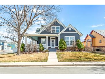 Charming two-story home with a cozy front porch, manicured lawn, and well-maintained landscaping at 5140 Mt Pawnee Ave, Frederick, CO 80504