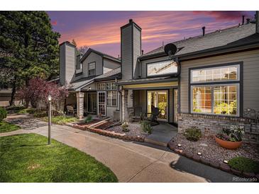 Charming townhouse exterior with manicured landscaping and private entrance under a colorful sunset sky at 4301 S Pierce St # 4D, Littleton, CO 80123