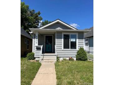 Charming single-story home with light gray siding, a small porch, and well-kept front lawn at 4875 Lowell Blvd, Denver, CO 80221