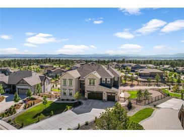 Beautiful two-story home with a three-car garage, lush landscaping, and mountain views at 5625 Heritage Oak Dr, Parker, CO 80134