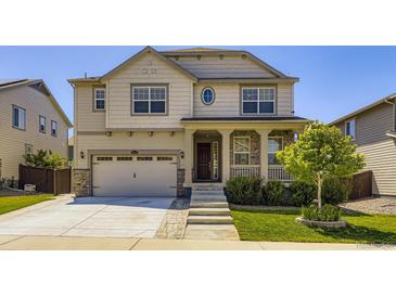 Charming two-story home with a well-manicured front yard and inviting porch at 14437 Grape St, Thornton, CO 80602