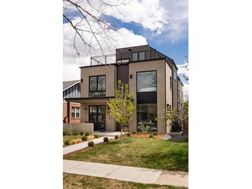 Modern two-story home featuring brick facade, rooftop patio, and manicured front lawn at 872 S Vine St, Denver, CO 80209