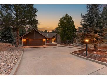 Inviting home exterior with a two-car garage and landscaping at 9724 E Villasur Ct, Parker, CO 80134