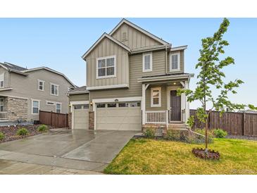 Charming two-story home featuring a two-car garage and inviting front porch, perfect for suburban living at 14687 Eudora St, Thornton, CO 80602