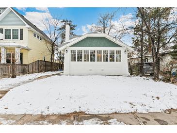 Charming bungalow with a newly renovated exterior and snow-covered front yard at 2167 S Emerson St, Denver, CO 80210