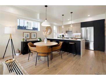 Modern dining area with light wood floors and stylish seating at 1260 N Stuart St # 2, Denver, CO 80204