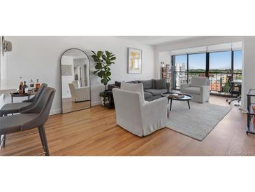 Bright living room with hardwood floors, city views, and modern furniture at 2 Adams St # 1401, Denver, CO 80206