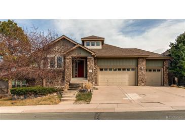 Charming two-story home features a two-car garage, stone accents, and well-maintained landscaping at 7132 S Irvington Ct, Aurora, CO 80016