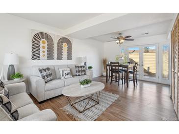 Bright living room features modern decor and a dining area with access to the patio at 1177 S Troy St, Aurora, CO 80012