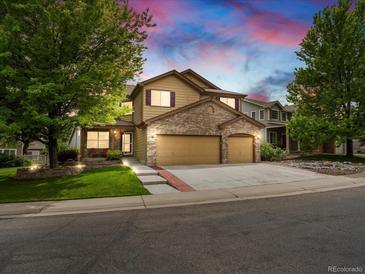 Charming two-story home boasts a brick facade and well-manicured lawn creating an inviting curb appeal at 6293 Braun Cir, Arvada, CO 80004