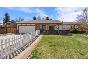Charming ranch-style home with a well-manicured lawn and a welcoming white picket fence at 4627 S Norfolk Way, Aurora, CO 80015