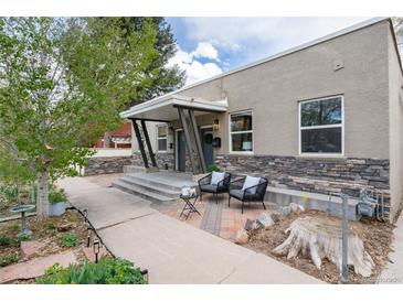 Charming home featuring a covered porch, stone accents, and a cozy seating area at 3220 W 24Th Ave, Denver, CO 80211