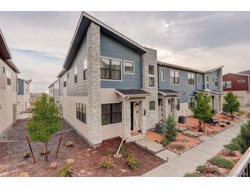 Charming townhome featuring stone accents, low maintenance yard, and modern architectural details at 9279 Merino Ct # D, Littleton, CO 80125