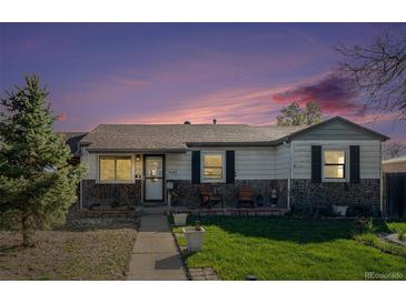 Charming single-story home with stone accents, a well-manicured lawn, and inviting front porch at 9450 Lillian Ln, Thornton, CO 80229