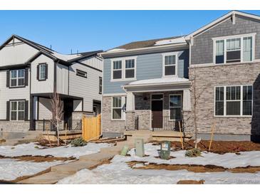 Charming two-story home featuring a mix of stone and siding, complemented by a well-manicured front yard at 773 N Tempe St, Aurora, CO 80018