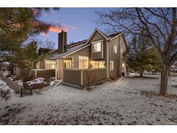 Charming townhome exterior with snowy front yard and landscaping at 6809 Zenobia St # 4, Westminster, CO 80030