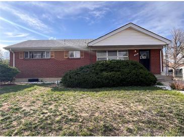 Charming brick home featuring a well-maintained front yard with lush green shrubbery at 10885 Mildred Dr, Northglenn, CO 80233