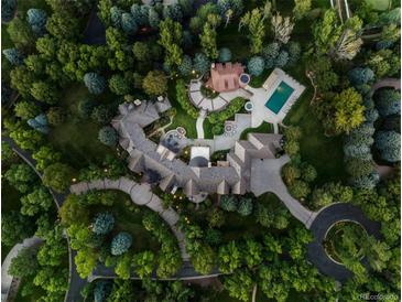 Stunning aerial view of estate featuring pool, lush landscaping, and winding driveway, showcasing the expansive property at 5 Mockingbird Ln, Cherry Hills Village, CO 80113