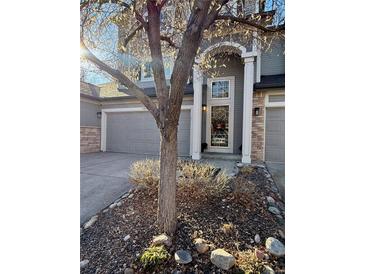 Charming two-story home featuring a well-manicured yard and attached two-car garage at 1469 S Ulster St, Denver, CO 80231