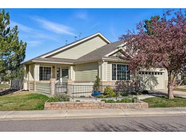 Charming single-story home with manicured lawn and inviting front porch with tasteful landscaping at 3930 Miller St, Wheat Ridge, CO 80033