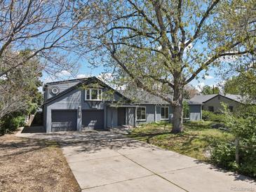 Charming home with a two-car garage and a spacious front yard, perfect for outdoor activities at 440 Balsam St, Lakewood, CO 80226