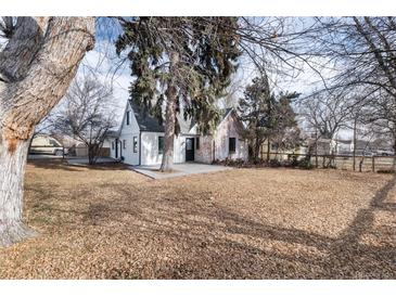 Charming craftsman home with a spacious front yard and mature trees at 9393 W 14Th Ave, Lakewood, CO 80215