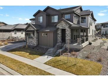 Charming home with a stone and wood facade, complemented by a well-manicured lawn at 3422 W 155Th Ave, Broomfield, CO 80023