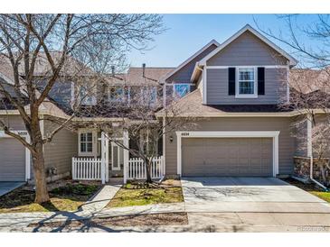 Charming two-story townhome with a well-maintained front yard and attached two-car garage on a sunny day at 6024 W Colorado Ln, Lakewood, CO 80232