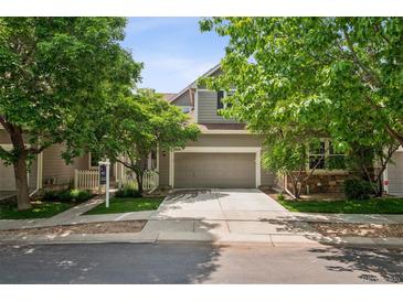 Charming home with a two-car garage, well-manicured lawn, mature trees, and a welcoming entrance at 6024 W Colorado Ln, Lakewood, CO 80232