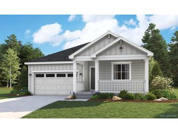 Charming single-story home with a light gray exterior, a well-maintained lawn, and an attached garage at 8436 Vona Ln, Littleton, CO 80125
