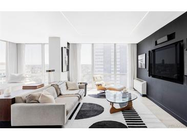 Bright, spacious living room with floor to ceiling windows and stylish modern furniture at 3100 E Cherry Creek South Dr # 1201, Denver, CO 80209