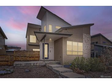 Modern two-story home with unique architecture, contemporary color palette and stylish front entry at 9715 Taylor River Cir, Littleton, CO 80125