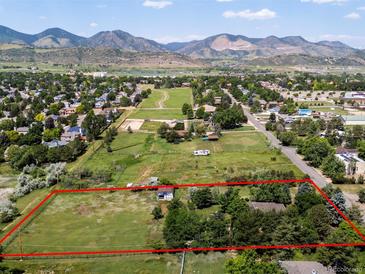 Expansive property featuring lush land and mountain views, outlined in red at 12196 W Belleview Dr, Littleton, CO 80127