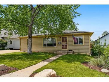 Charming single-story home with a well-manicured lawn and a mature shade tree at 5573 S Datura St, Littleton, CO 80120