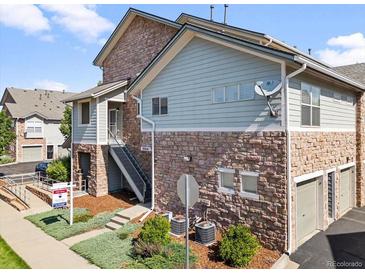 Multi-level exterior showcasing stone accents, stairs to the entrance, and manicured landscaping at 18661 E Water Dr # F, Aurora, CO 80013