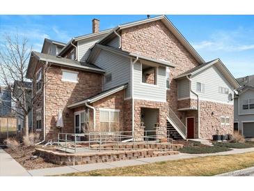 Attractive townhouse with stone accents, hardiplank siding, and well-maintained landscaping at 18661 E Water Dr # F, Aurora, CO 80013