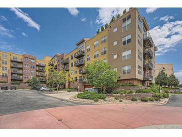 Beautiful condo building with balconies, landscaping, and a well-maintained parking area at 9079 E Panorama Cir # 309, Englewood, CO 80112