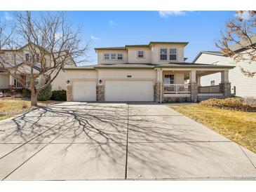 Charming two-story home with a three car garage and a covered front porch at 6445 S Telluride St, Aurora, CO 80016