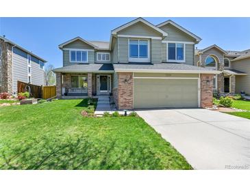 Inviting two-story home features a well-manicured lawn and attached two-car garage at 5394 S Gray St, Littleton, CO 80123