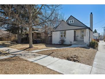 Charming gray and white two-story home with sidewalk leading to the front door at 4022 E 17Th Avenue Pkwy, Denver, CO 80220
