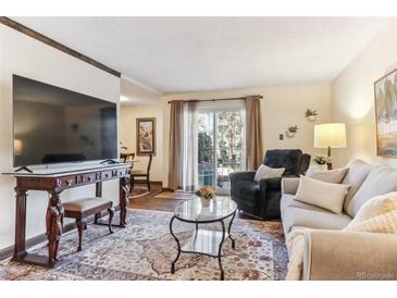 Cozy living room with natural light and comfortable seating arrangement at 2375 S Linden Ct # 118, Denver, CO 80222