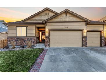 Inviting single-Gathering home with a three-car garage, stone accents, and a well-manicured lawn at 13015 Tamarac Pl, Thornton, CO 80602