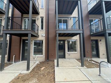 Modern townhome exterior featuring private balconies and a contemporary brick and wood facade at 1652 N Lafayette St # 6, Denver, CO 80218
